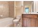Bathroom featuring a tub, toilet, vanity with dark wood cabinets, and neutral walls at 12091 Firewheel Pl, Venice, FL 34293