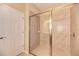 Bathroom with tiled shower, glass door, and neutral paint at 12091 Firewheel Pl, Venice, FL 34293