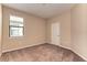 Well-lit bedroom featuring a window and neutral carpet, paint, and trim at 12091 Firewheel Pl, Venice, FL 34293
