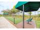 Scenic bocce ball court with shaded seating areas and lush landscaping at 12091 Firewheel Pl, Venice, FL 34293