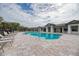 Community pool with ample lounge chairs and inviting landscaping, creating a resort-like experience at 12091 Firewheel Pl, Venice, FL 34293