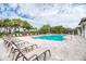 Inviting community pool with lounge chairs and well-maintained landscaping, perfect for relaxation at 12091 Firewheel Pl, Venice, FL 34293