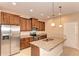 Modern kitchen features a granite island, stainless steel appliances, and custom wood cabinetry at 12091 Firewheel Pl, Venice, FL 34293