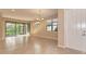 Bright living room featuring tiled floors, ample natural light, and access to an outdoor area at 12091 Firewheel Pl, Venice, FL 34293