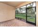 Screened lanai with brick flooring and views of the backyard, perfect for relaxation at 12091 Firewheel Pl, Venice, FL 34293