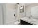Clean bathroom with a shower and tub combination, single vanity and an art piece at 12104 Kingsley Trl, Parrish, FL 34219