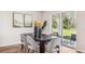 Dining area with modern decor, sliding doors leading to an outdoor patio and view to backyard at 12108 Kingsley Trl, Parrish, FL 34219