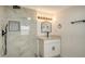 Bathroom featuring tiled walk-in shower and modern fixtures, plus ample lighting at 1227 Porpoise Rd, Venice, FL 34293