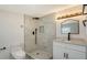 The renovated bathroom features a tiled walk-in shower and modern fixtures at 1227 Porpoise Rd, Venice, FL 34293