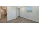 Bright bedroom with wood-look floors, closet, and a window with blinds at 1227 Porpoise Rd, Venice, FL 34293