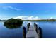 Picturesque wooden dock extending into the calm blue water, perfect for relaxing at 1227 Porpoise Rd, Venice, FL 34293