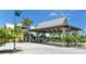 Covered entrance area with well-maintained landscaping and a blue sky backdrop at 1227 Porpoise Rd, Venice, FL 34293