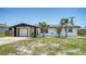 Charming single story home featuring well-maintained landscaping and attached garage at 1227 Porpoise Rd, Venice, FL 34293