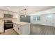 Modern kitchen featuring stainless steel appliances, quartz counters, and an open floor plan at 1227 Porpoise Rd, Venice, FL 34293