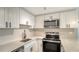 Beautifully renovated kitchen with stainless appliances, quartz counters, and bright lighting at 1227 Porpoise Rd, Venice, FL 34293