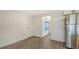 Efficient kitchenette with stainless steel refrigerator, luxury vinyl flooring and white trim at 1227 Porpoise Rd, Venice, FL 34293