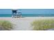Picturesque lifeguard stand on a sandy beach with calm turquoise water and a clear blue sky at 1227 Porpoise Rd, Venice, FL 34293