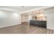 Open living room, showcasing vinyl plank flooring and bar seating to kitchen at 1227 Porpoise Rd, Venice, FL 34293