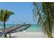 Scenic pier view showcasing a lengthy pier with benches and lights extending into the ocean at 1227 Porpoise Rd, Venice, FL 34293