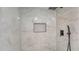 The walk-in shower is tiled and features black hardware and a niche at 1227 Porpoise Rd, Venice, FL 34293