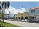 Charming street with shops, palm trees, and parked cars under a bright sky at 1227 Porpoise Rd, Venice, FL 34293