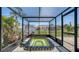 Enclosed sunroom featuring a sunken hot tub, tiled floors, and views of the backyard at 1227 Porpoise Rd, Venice, FL 34293