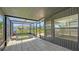 Enclosed sunroom featuring a sunken hot tub, tiled floors, and views of the backyard at 1227 Porpoise Rd, Venice, FL 34293