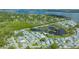 Drone view showcasing the neighborhood, its proximity to water, and lush green surroundings at 13 Oak St, Bradenton, FL 34208
