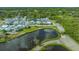 An aerial view showcasing the property's location near a scenic pond and community layout at 13 Oak St, Bradenton, FL 34208