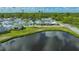 Aerial view featuring the home's picturesque setting near a pond and green landscape at 13 Oak St, Bradenton, FL 34208