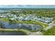 An aerial view capturing the charming neighborhood, water features, and lush greenery at 13 Oak St, Bradenton, FL 34208