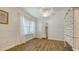 This bedroom showcases shiplap walls, two windows with curtains, and access to a closet at 13 Oak St, Bradenton, FL 34208