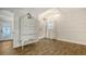 This bedroom is spacious, with wood-look floors, shiplap walls, a decorative dresser, and ensuite bathroom at 13 Oak St, Bradenton, FL 34208
