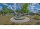 Charming fountain surrounded by greenery and trees at Historic Braden Castle community at 13 Oak St, Bradenton, FL 34208