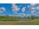 Scenic view of the community pond with benches and lush greenery in Historic Braden Castle at 13 Oak St, Bradenton, FL 34208