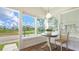 Cozy dining area with a quaint table set beside large windows, offering peaceful water views at 13 Oak St, Bradenton, FL 34208