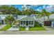 A quaint stone cottage with lush lawns and ample parking, radiating charm at 13 Oak St, Bradenton, FL 34208