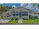 Charming home with stone facade, covered parking, lush lawn, and inviting entryway at 13 Oak St, Bradenton, FL 34208