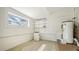 Bright laundry area with floating shelves, modern water heater, and an included washer/dryer appliance at 13 Oak St, Bradenton, FL 34208