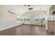 Spacious open living area with wood-look flooring, shiplap walls, and an abundance of natural light at 13 Oak St, Bradenton, FL 34208