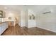 Open-concept space boasts hardwood floors, shiplap walls, and natural light, ideal for relaxing or entertaining at 13 Oak St, Bradenton, FL 34208