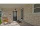 Covered patio area with stone accents and access to two exterior doors at 13 Oak St, Bradenton, FL 34208