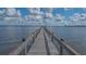 Long wooden pier stretching over the water offering a tranquil view of the surrounding scenery at 13 Oak St, Bradenton, FL 34208