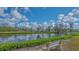 Scenic view of the pond with a sitting bench on a sunny day at 13 Oak St, Bradenton, FL 34208