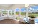 Bright sunroom featuring expansive windows overlooking lush outdoor scenery, and wood-look floors at 13 Oak St, Bradenton, FL 34208