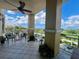 Spacious balcony with views of the water and palm trees, featuring outdoor seating and lush plants at 130 Riviera Dunes Way # 304, Palmetto, FL 34221