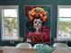 Bright dining area with a colorful artistic print and views from the large windows at 130 Riviera Dunes Way # 304, Palmetto, FL 34221