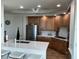 Spacious kitchen featuring stainless steel appliances and a quartz countertop at 130 Riviera Dunes Way # 304, Palmetto, FL 34221