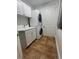 Functional laundry room featuring a stacked washer and dryer, utility sink, and storage cabinets at 130 Riviera Dunes Way # 304, Palmetto, FL 34221