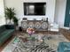 Comfortable living room with stylish décor, including a modern sofa, glass coffee table, and decorative accents at 130 Riviera Dunes Way # 304, Palmetto, FL 34221